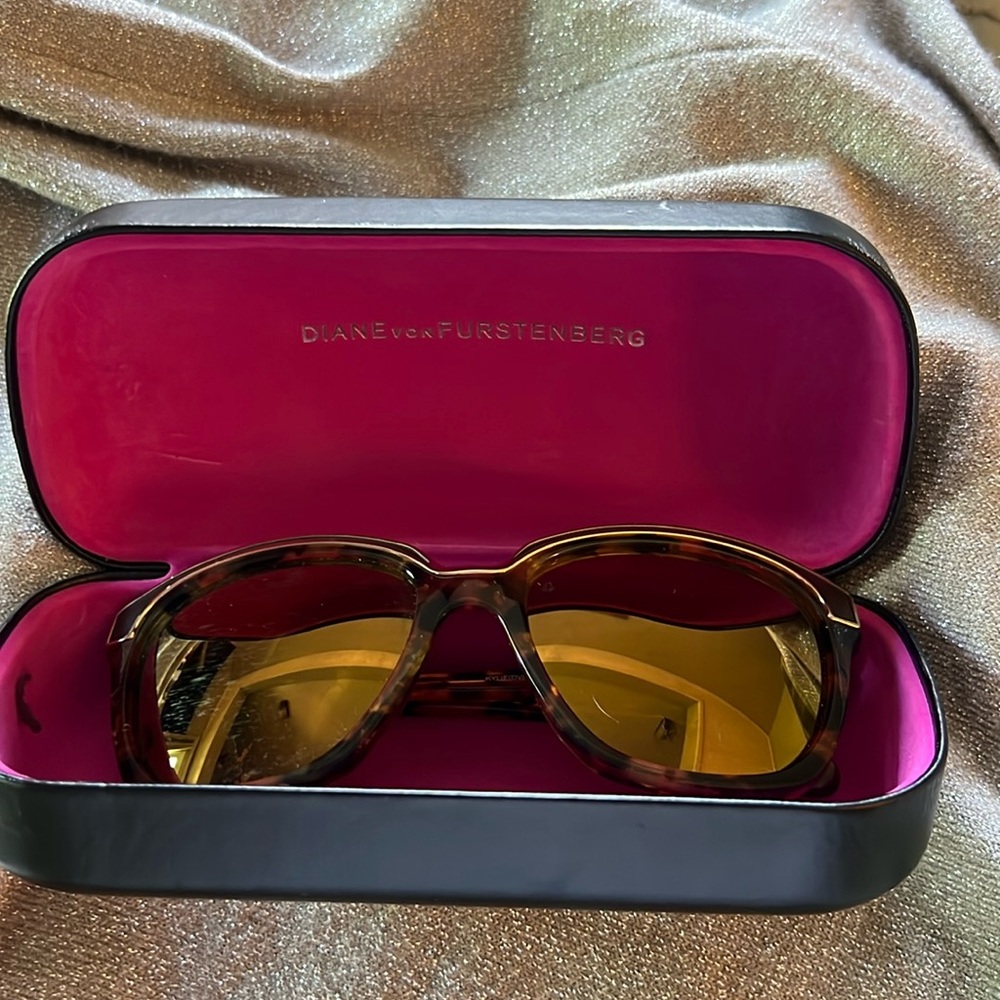 Diane von Furstenberg sunglasses tortoiseshell frame with gold detailing.